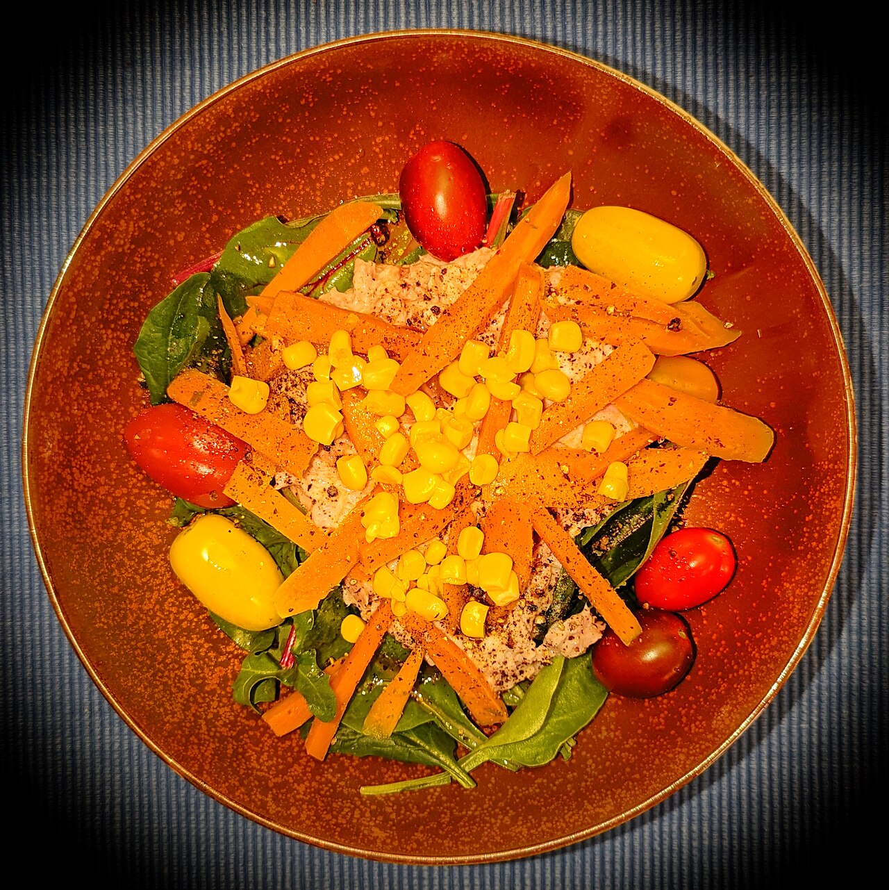 Tuna salad on mixed greens, with corn, carrots, tomatoes, olive oil, red vinegar, and black pepper - Massachusetts